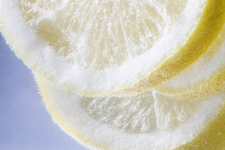 Lemon slices against white background, closeupの写真素材