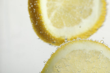Soda water with lemon slices as background, closeupの写真素材