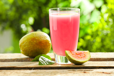 Refreshing guava juice and fresh fruits on wooden table, closeupの写真素材