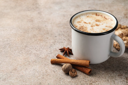 Aromatic Masala tea in cup and spices on grey table, closeup. Space for textの写真素材
