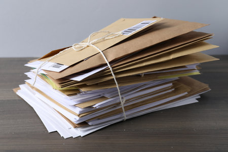 Stack of different paper envelopes on wooden table, closeup. Post officeの写真素材