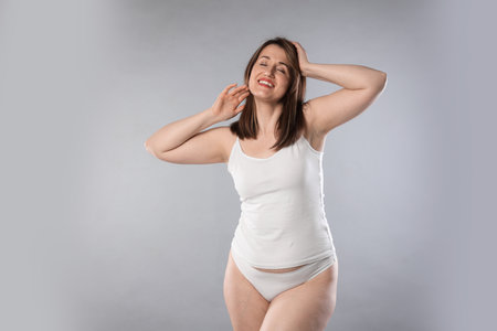 Woman in underwear on light grey background. Cellulite problemの写真素材