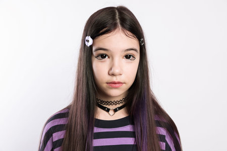 Teenage girl in stylish clothes and accessories posing on white background. Makeup in anime style