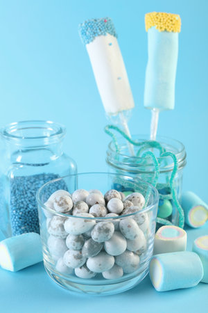 Candy bar. Many different sweets on light blue backgroundの写真素材