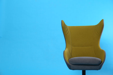 Comfortable office chair on light blue background, space for textの写真素材