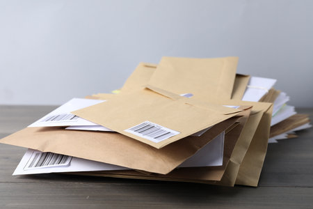 Stack of different paper envelopes on wooden table, closeup. Post officeの写真素材
