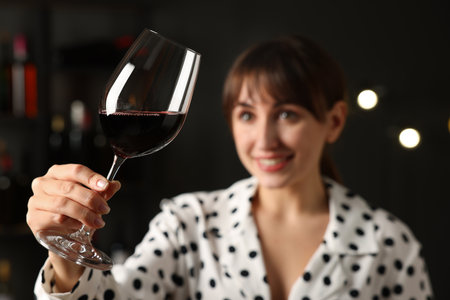 Professional sommelier analyzing quality of red wine indoors, selective focusの写真素材