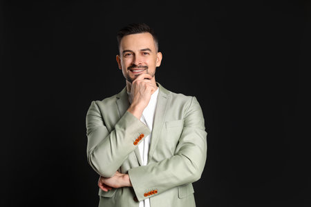 Portrait of handsome middle aged man on black backgroundの写真素材