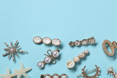 Different hair clips on light blue background, flat lay. Space for textの写真素材