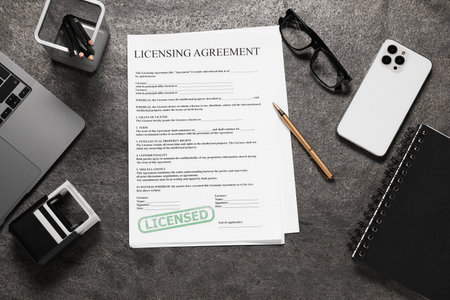 Flat lay composition with licensing agreement document on gray textured tableの写真素材