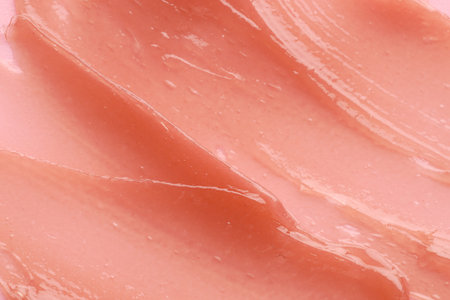 Moisturizing lip balm as background, above view
