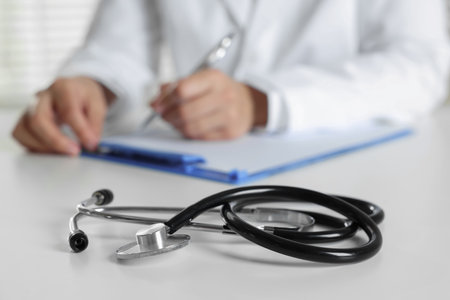 Doctor working and stethoscope on table in hospital, selective focusの写真素材