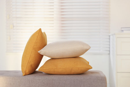Soft decorative pillows on sofa in roomの写真素材