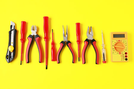 Different electrical tools on yellow background, flat layの写真素材