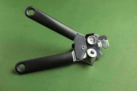 One can opener on green background, closeup