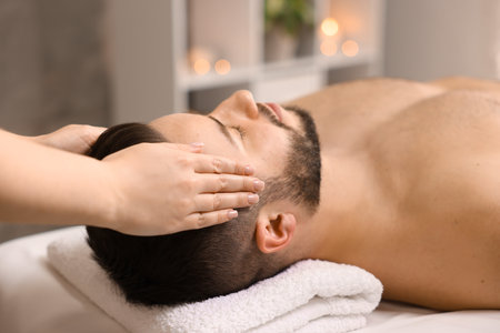 Man receiving relaxing massage in spa salonの写真素材