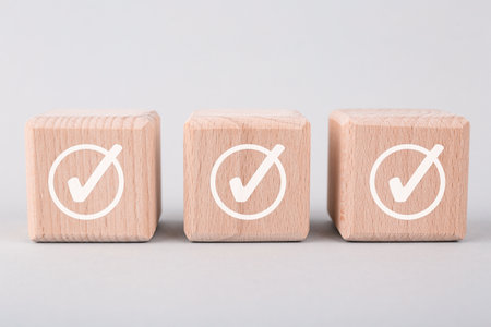 Wooden cubes with check marks on grey background, closeupの写真素材