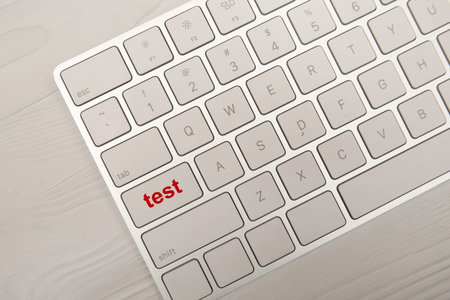 Online test. Computer keyboard with word on button, top view