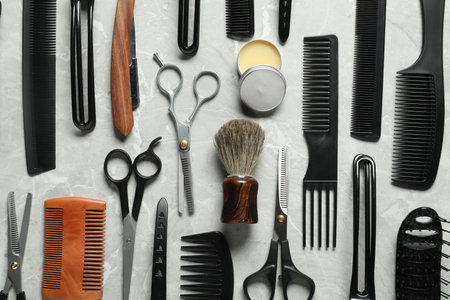 Many different barber's tools on light grey table, flat layの写真素材