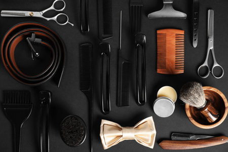 Many different barber's tools on black table, flat layの写真素材