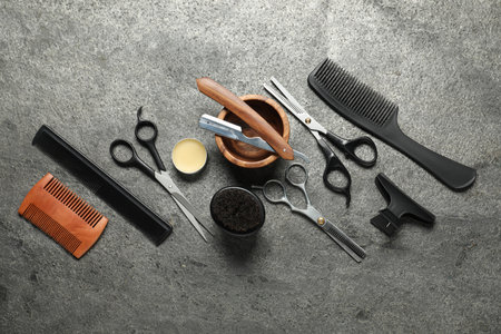 Many different barber's tools on grey textured table, flat layの写真素材