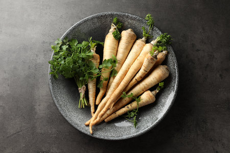 Parsley roots with leaves on black table, top viewの写真素材