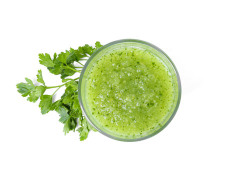Healthy parsley smoothie in glass and leaves isolated on white, top viewの写真素材