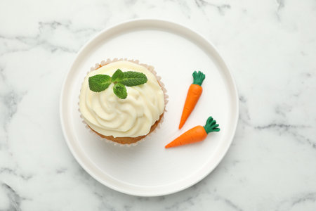 Carrot cupcake with mint on white marble table, top viewの写真素材