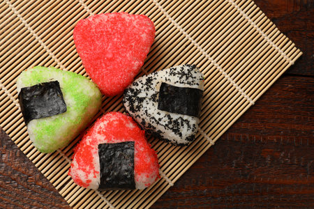 Tasty tobiko onigiri (Japanese rice balls) served on wooden table, top viewの写真素材