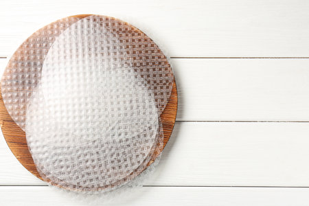 Edible rice paper sheets on white wooden table, top view. Space for textの写真素材