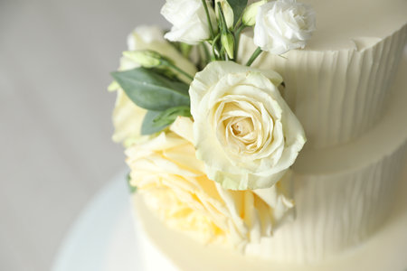 Delicious wedding cake with floral decor on blurred background, closeupの写真素材