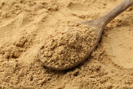 Superfood supplement. Turmeric powder and spoon, closeupの写真素材