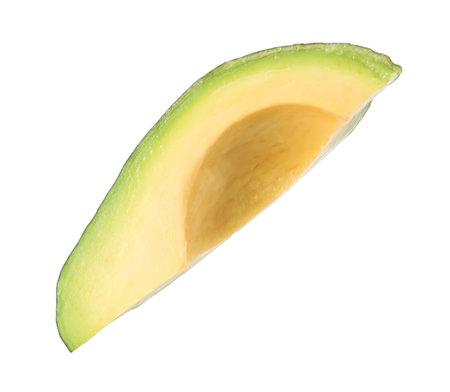 Slice of ripe avocado in air isolated on whiteの写真素材
