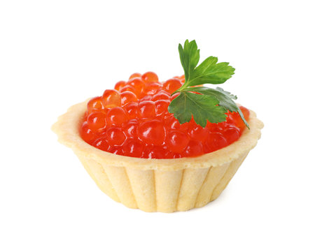 Tartlet with red caviar and parsley isolated on whiteの写真素材