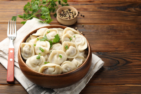 Delicious dumplings served on wooden table, space for textの写真素材