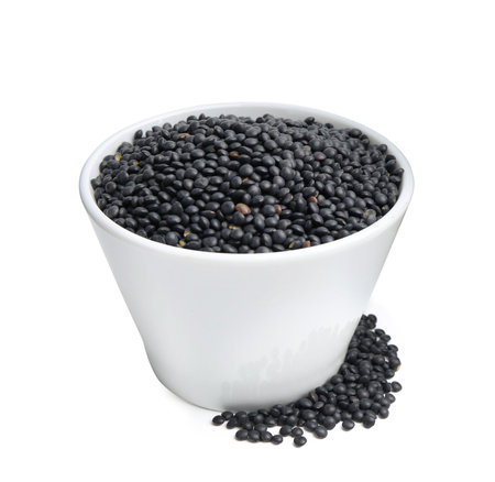 Black lentils in bowl isolated on whiteの写真素材