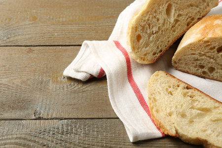 Slices of fresh bread on wooden table, closeup. Space for textの写真素材