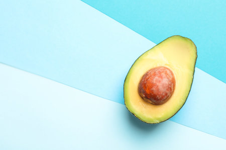 Half of fresh avocado on color background, top view. Space for textの写真素材