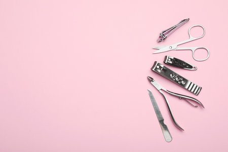 Set of different manicure tools on pink background, flat lay. Space for textの写真素材