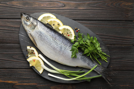 Salted herring and spices on wooden table, top viewの写真素材