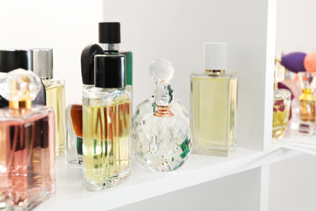 Different bottles of luxury perfume on shelf in store, closeupの写真素材