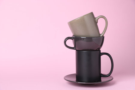 Different cups on pink background, closeup. Space for textの写真素材