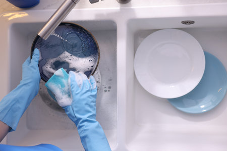 Washing dishes in kitchen sink, top viewの写真素材