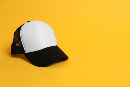 Blank baseball cap for branding on orange background. Mockup for designの写真素材