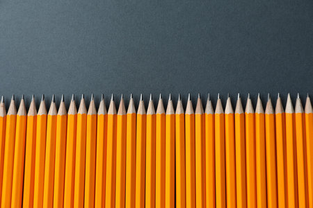 Many pencils on gray background, flat lay. Space for textの写真素材