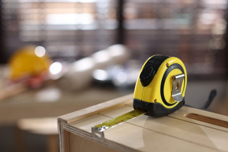 Measuring tape on wooden shelf, closeup. Space for textの写真素材