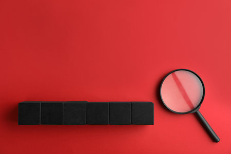 Word SEARCH made of black cubes and magnifier glass on red background, flat lay with space for text. Find keywords conceptの写真素材