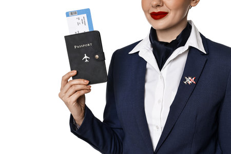 Stewardess holding passport with flight ticket on white background, closeupの写真素材