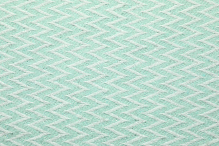 Light blue woolen fabric with geometrical pattern as background, top view