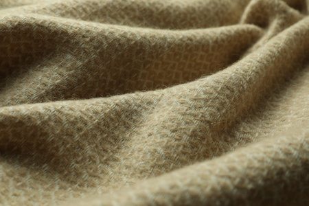 Beige woolen fabric with geometrical pattern, closeup